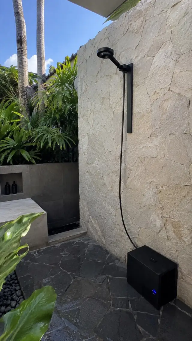 Olsek Ice Shower installed in an outdoor stone shower